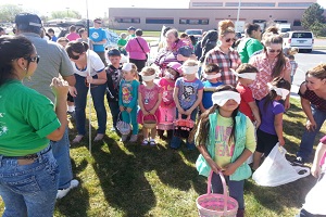 Children with their Easter Baskets get instructions for the Annual Easter Egg Hunt