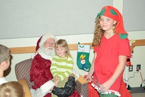 Santa and his Elf Visit with Children at our Annual Christmas Party